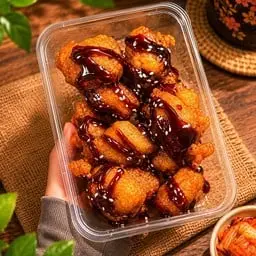 Small pieces of chicken coated in batter and deep-fried, topped with sauce (choose your sauce).