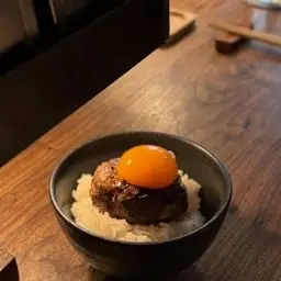 Garlic fried rice with pork hamburger patty and pickled egg.