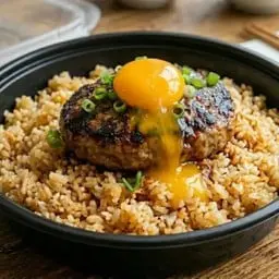 Rice with hamburger patty and pickled egg.