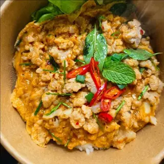 Rice with creamy scrambled eggs and minced pork wrapped in banana leaves.