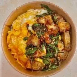 Rice with creamy scrambled eggs and crispy pork basil.