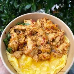 Rice with creamy scrambled eggs and basil chicken.